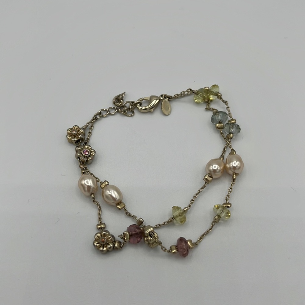 Metal bracelet with multiple pendants and stones